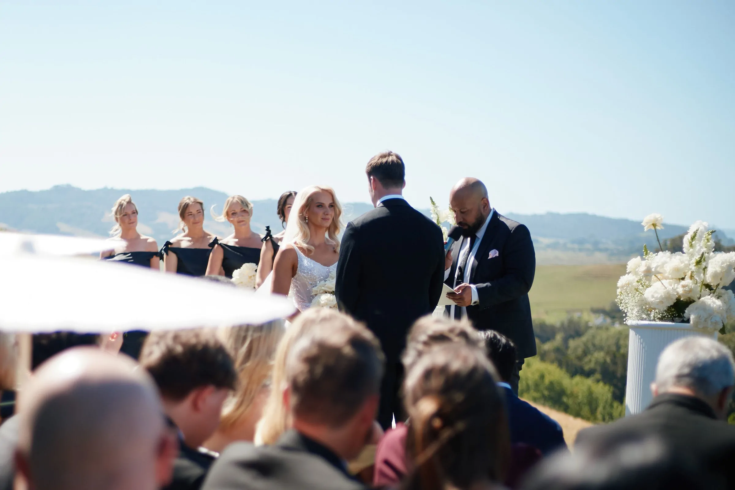 Nate Dunn officiating a wedding ceremony at Kauri Bay in Clevedon