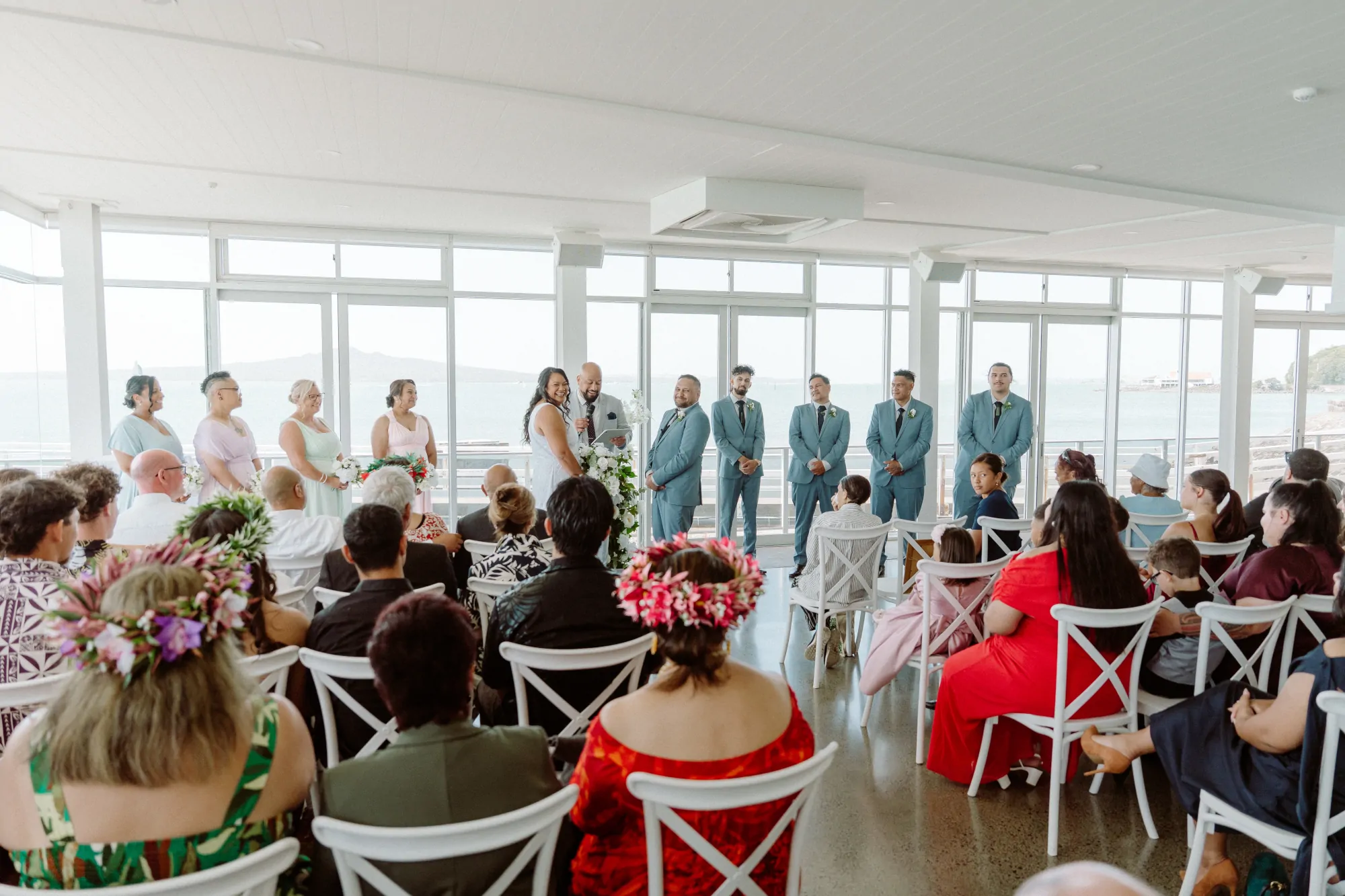 Nate Dunn officiating a wedding ceremony at okahu bay in Orakei