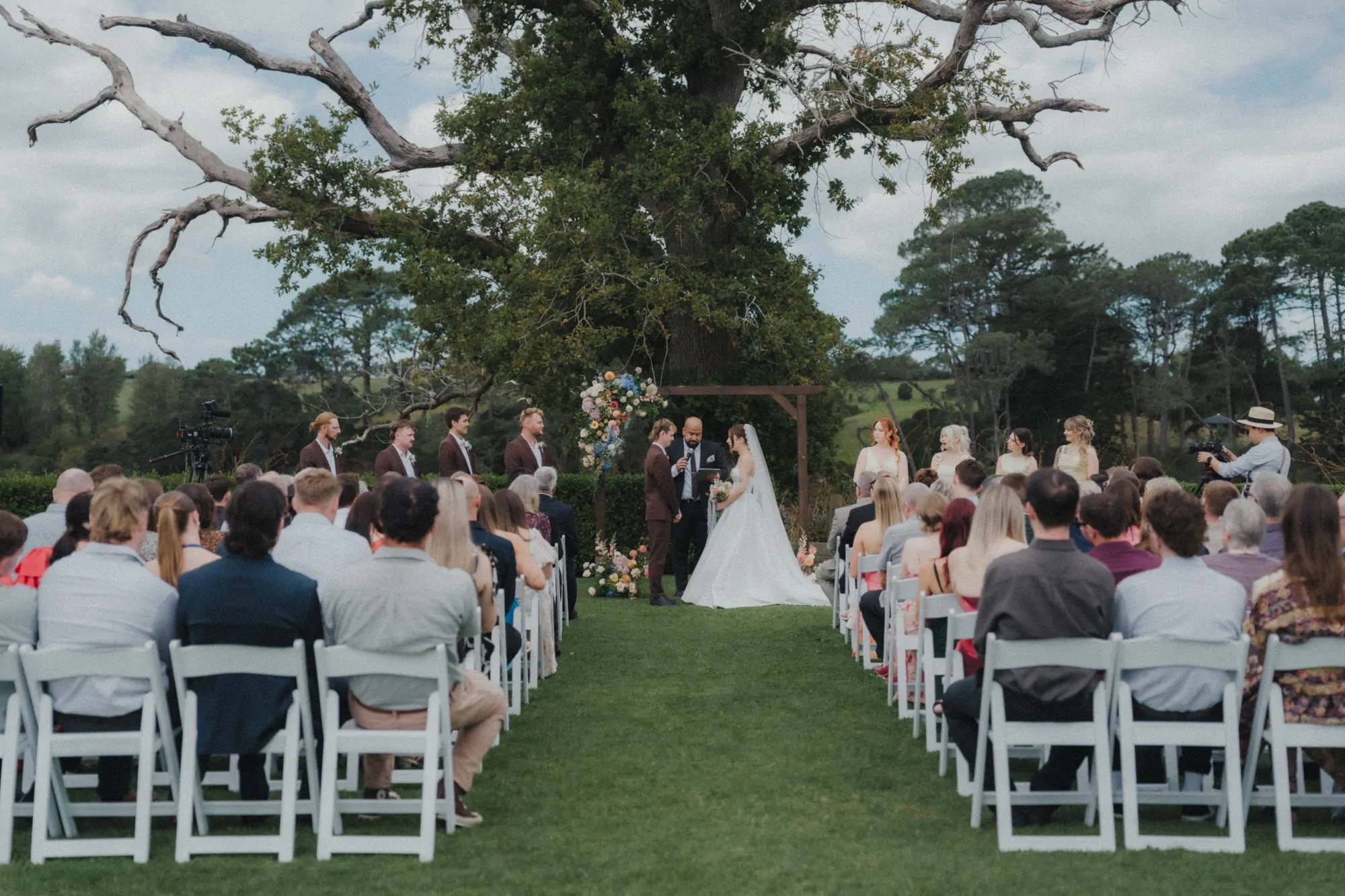 Nate Dunn officiating a wedding ceremony at The Boat House at the Riverhead in Riverhead