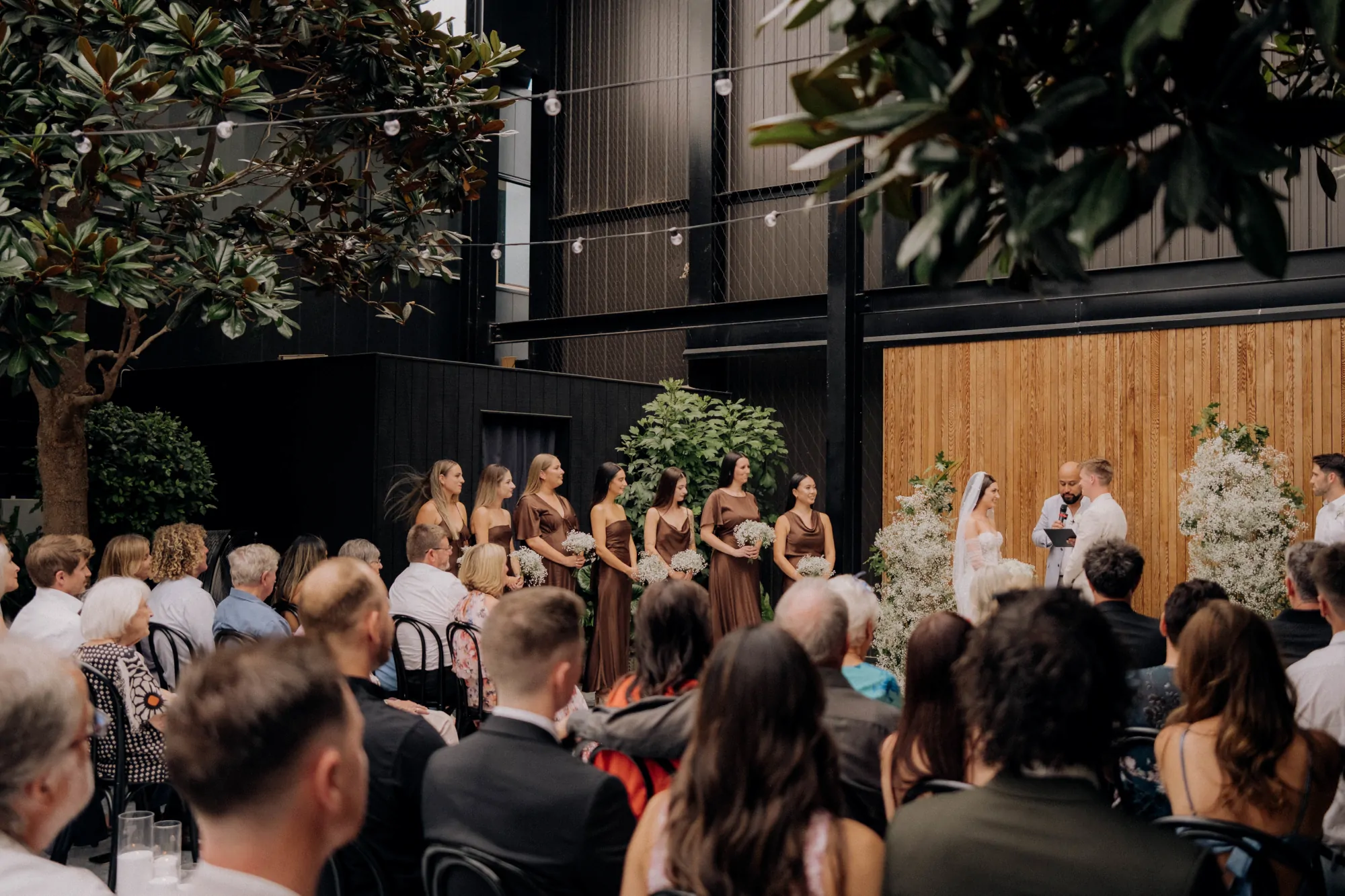 Nate Dunn officiating a wedding ceremony at Glasshouse Morningside in Auckland